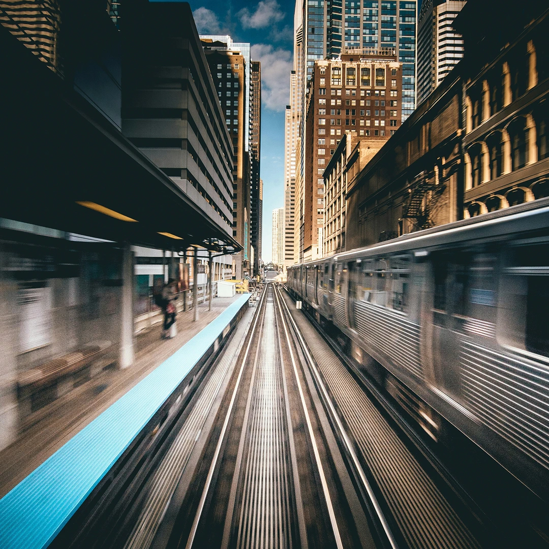 Cityscape with a train approaching a station