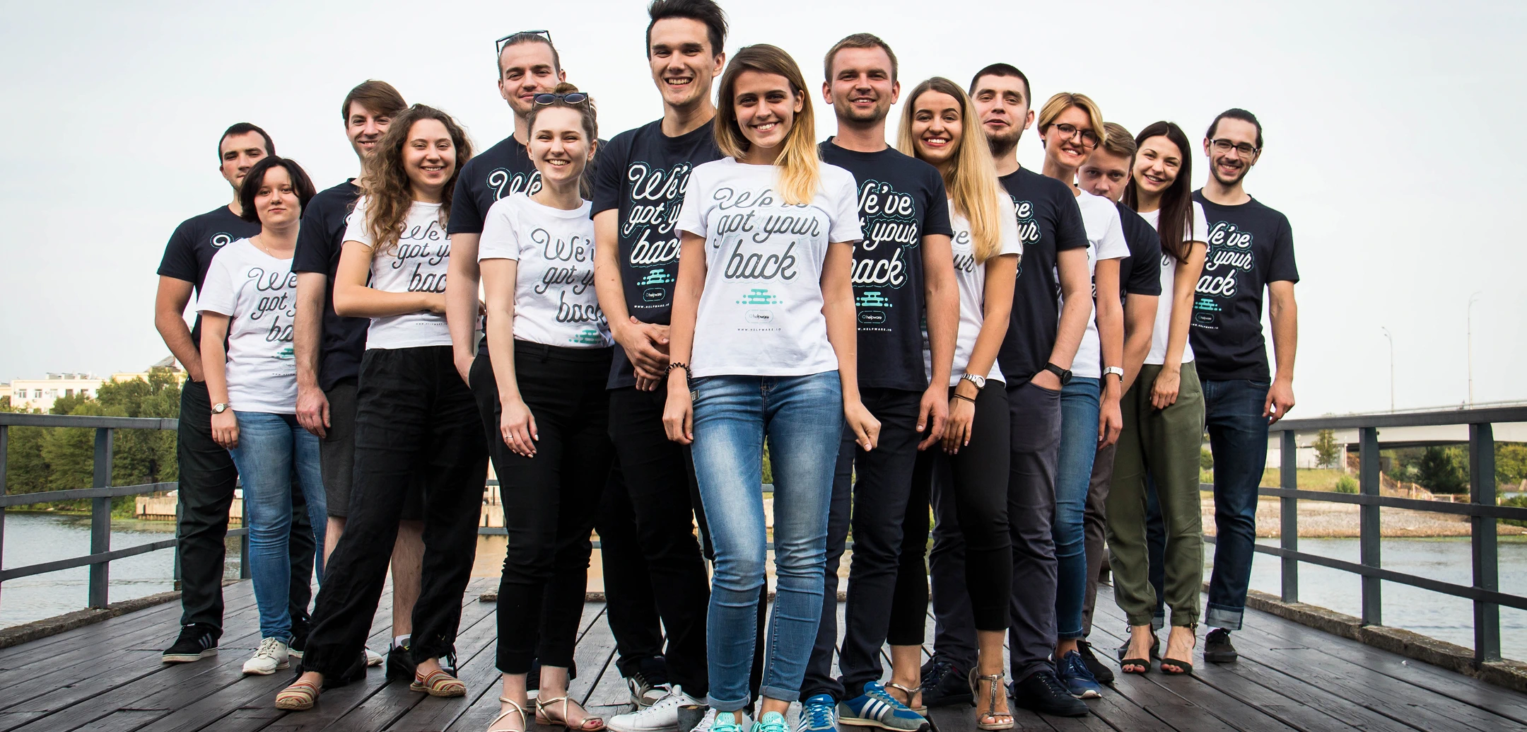 Group of Cognitime employees wearing branded t-shirts with the slogan 'We've got your back'