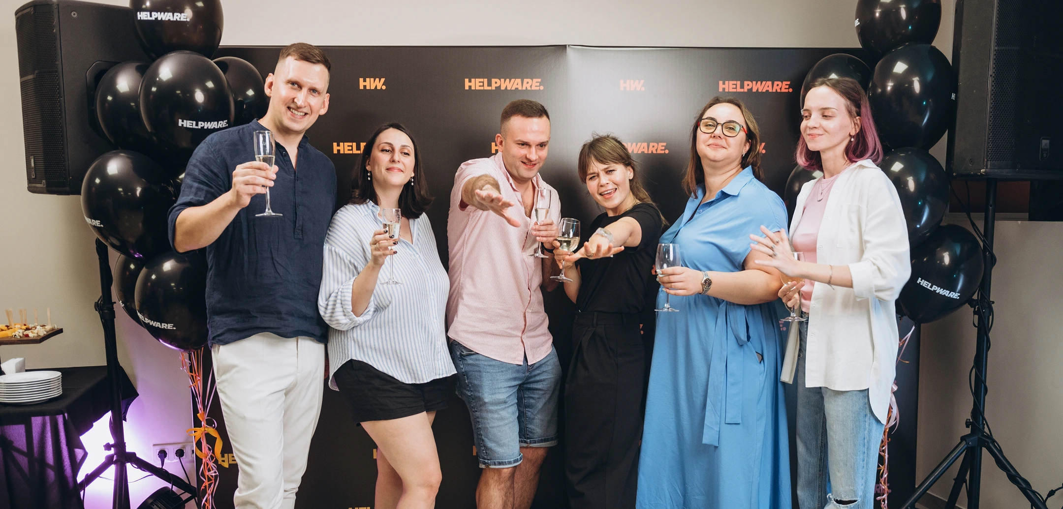 Enthusiastic Cognitime employees toasting with champagne at a company celebration.
