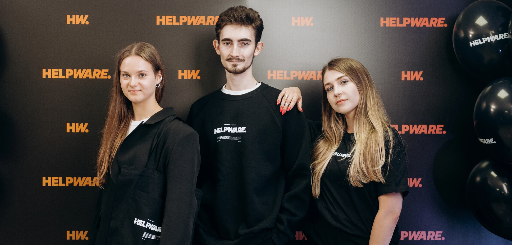 Three Cognitime team members wearing branded company clothing