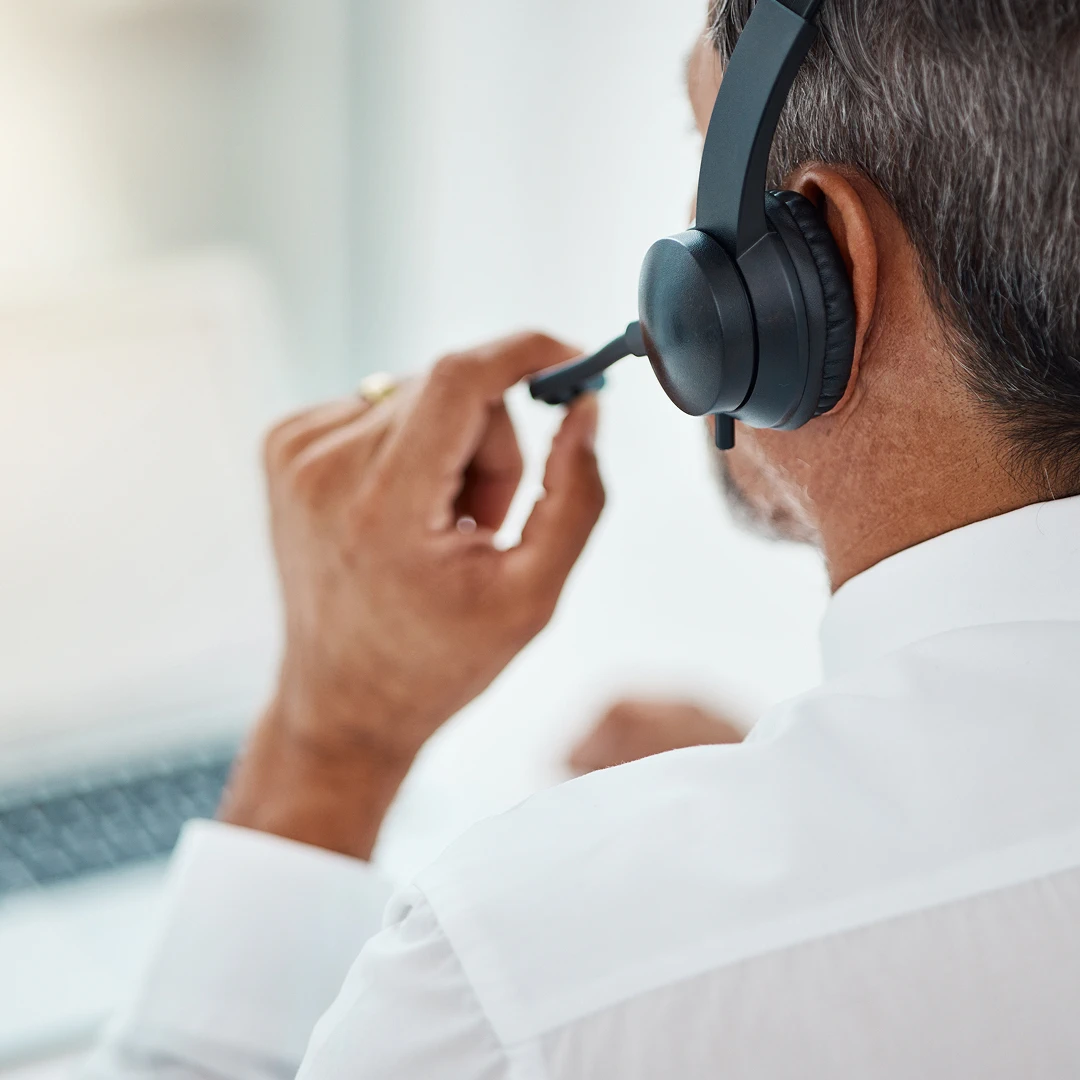 Rear view of a customer service agent wearing a headset with a microphone