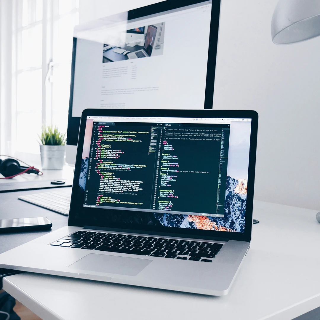 Desk with an open laptop and an additional monitor