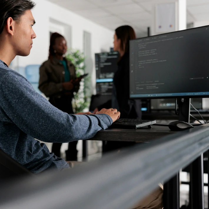 asian guy coding on a PC