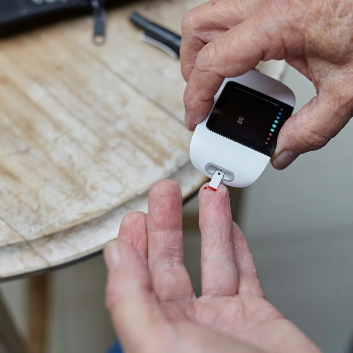 a senior using glucose meter